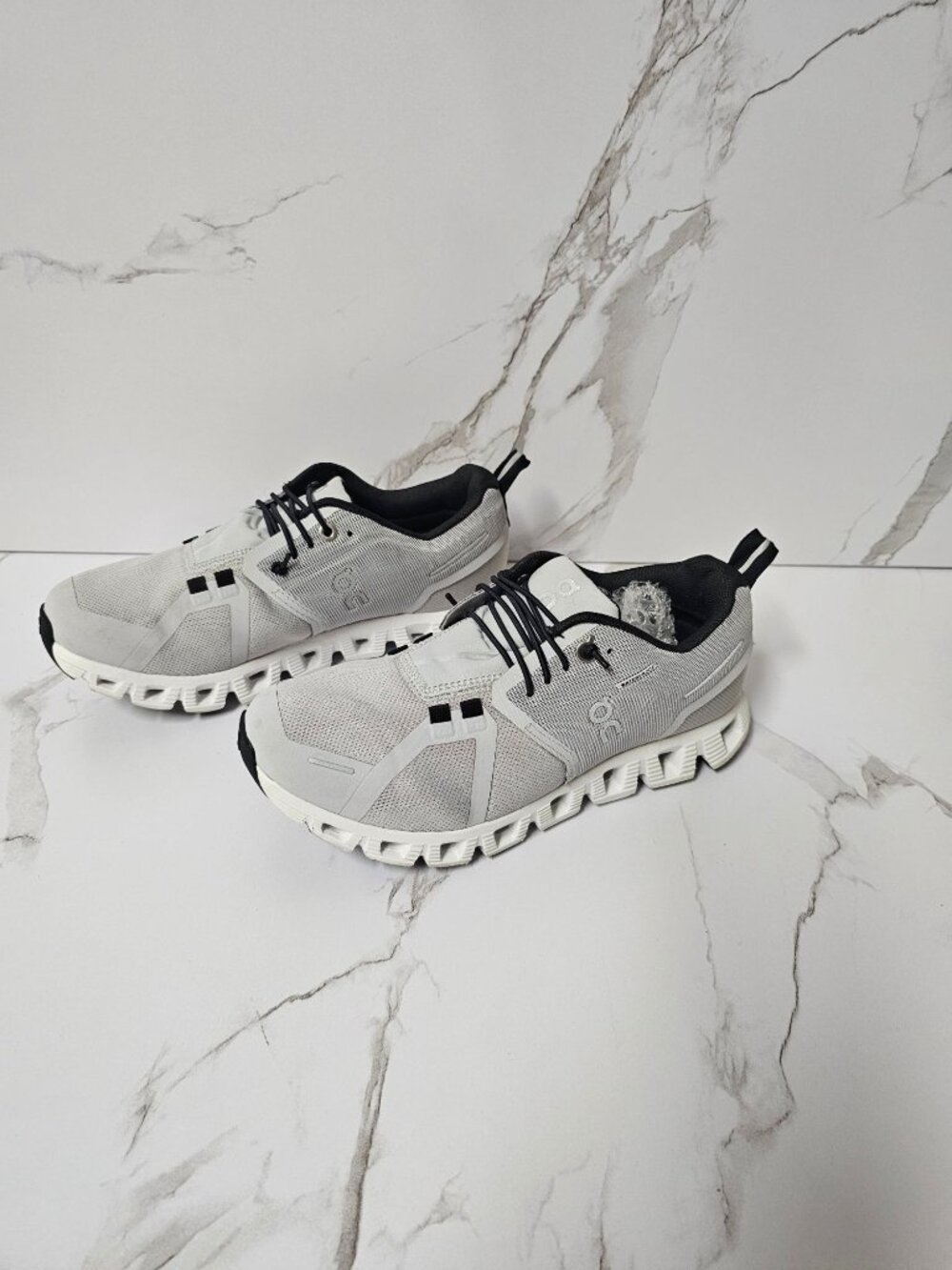 On Cloud 5 Waterproof sneakers in the Glacier/White colorway.